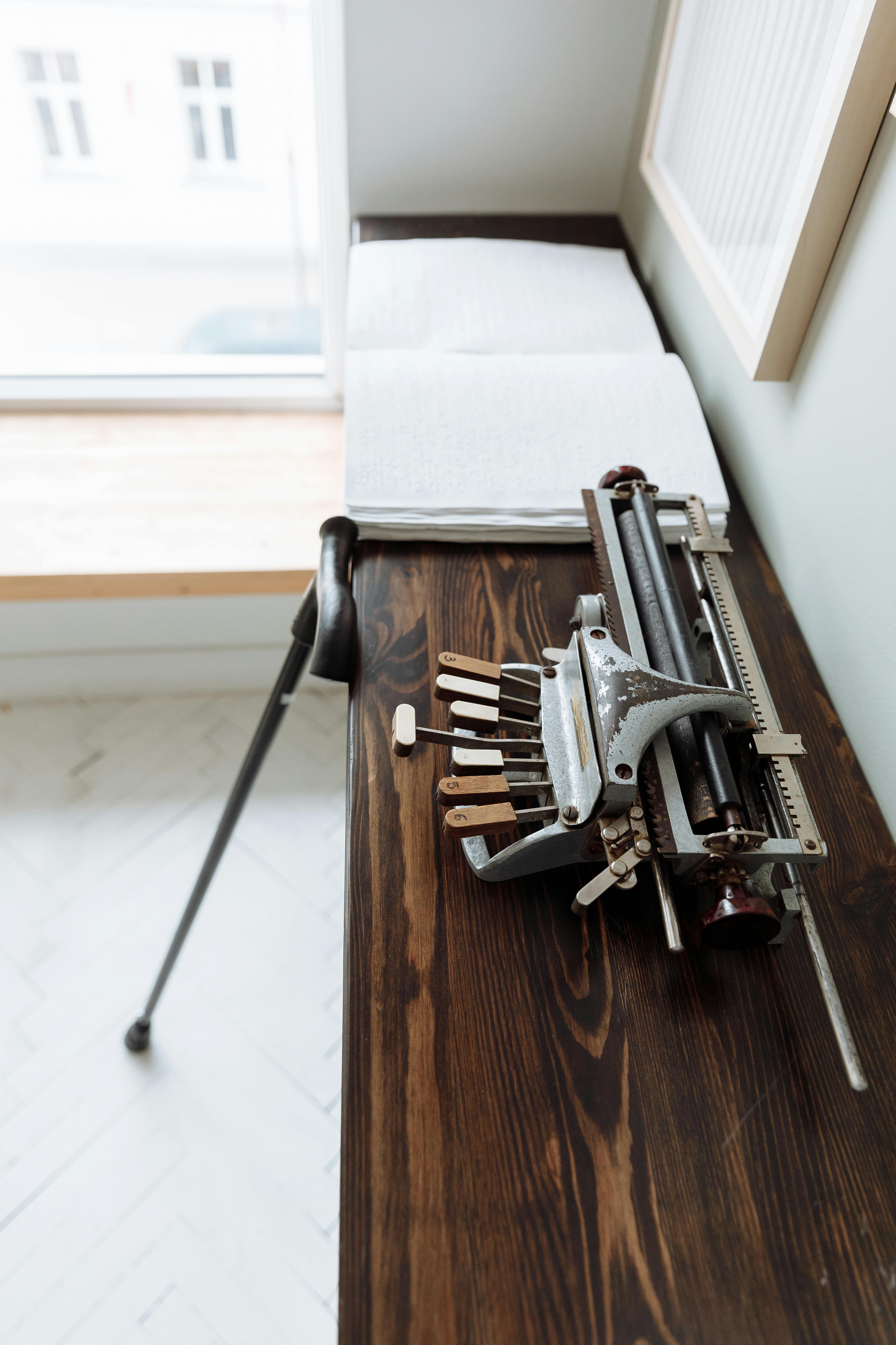 gray and black metal tool on brown wooden table