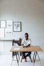 Man in White Dress Shirt Sitting Beside Brown Wooden Table