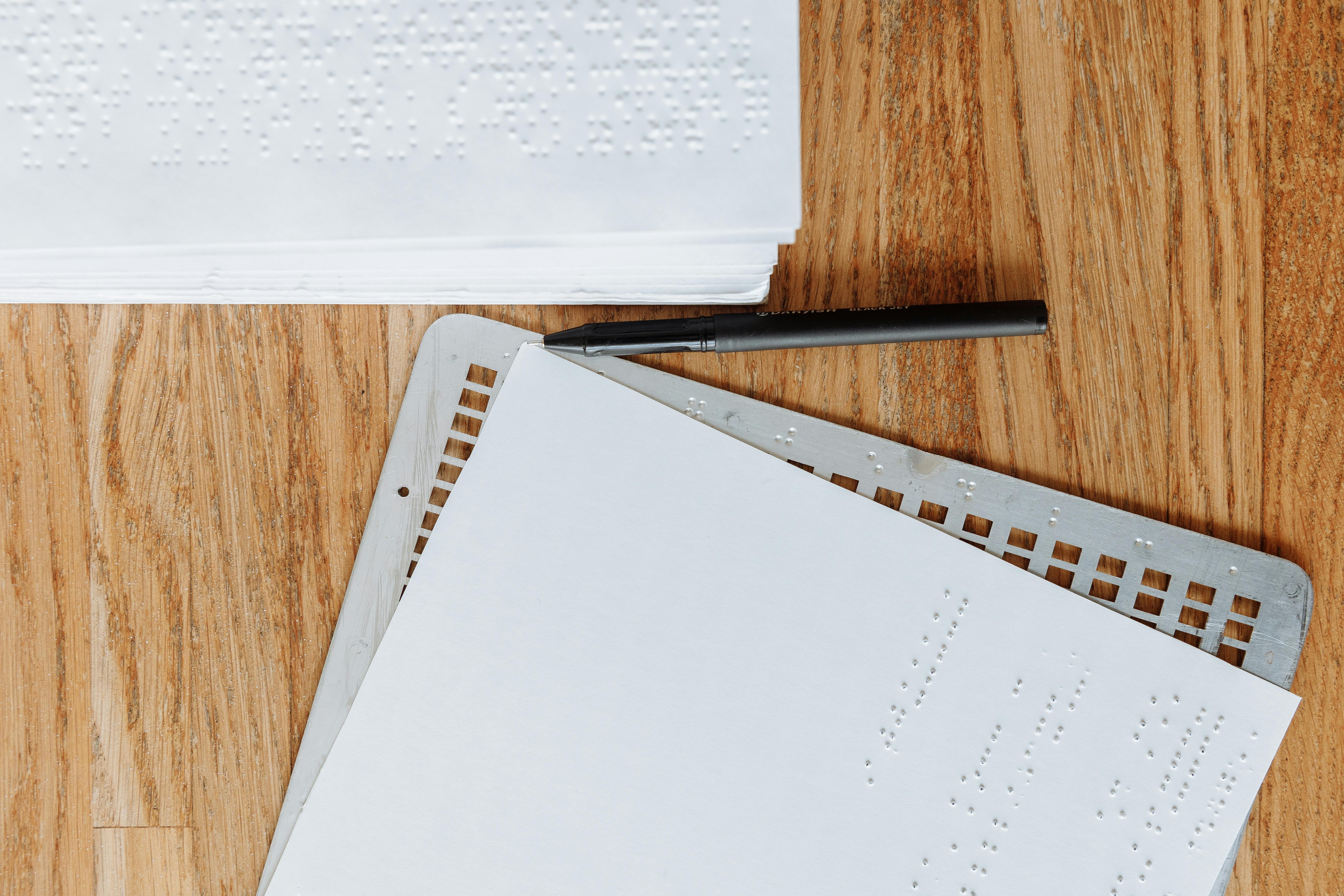 White Braille Paper on Brown Wooden Table · Free Stock Photo