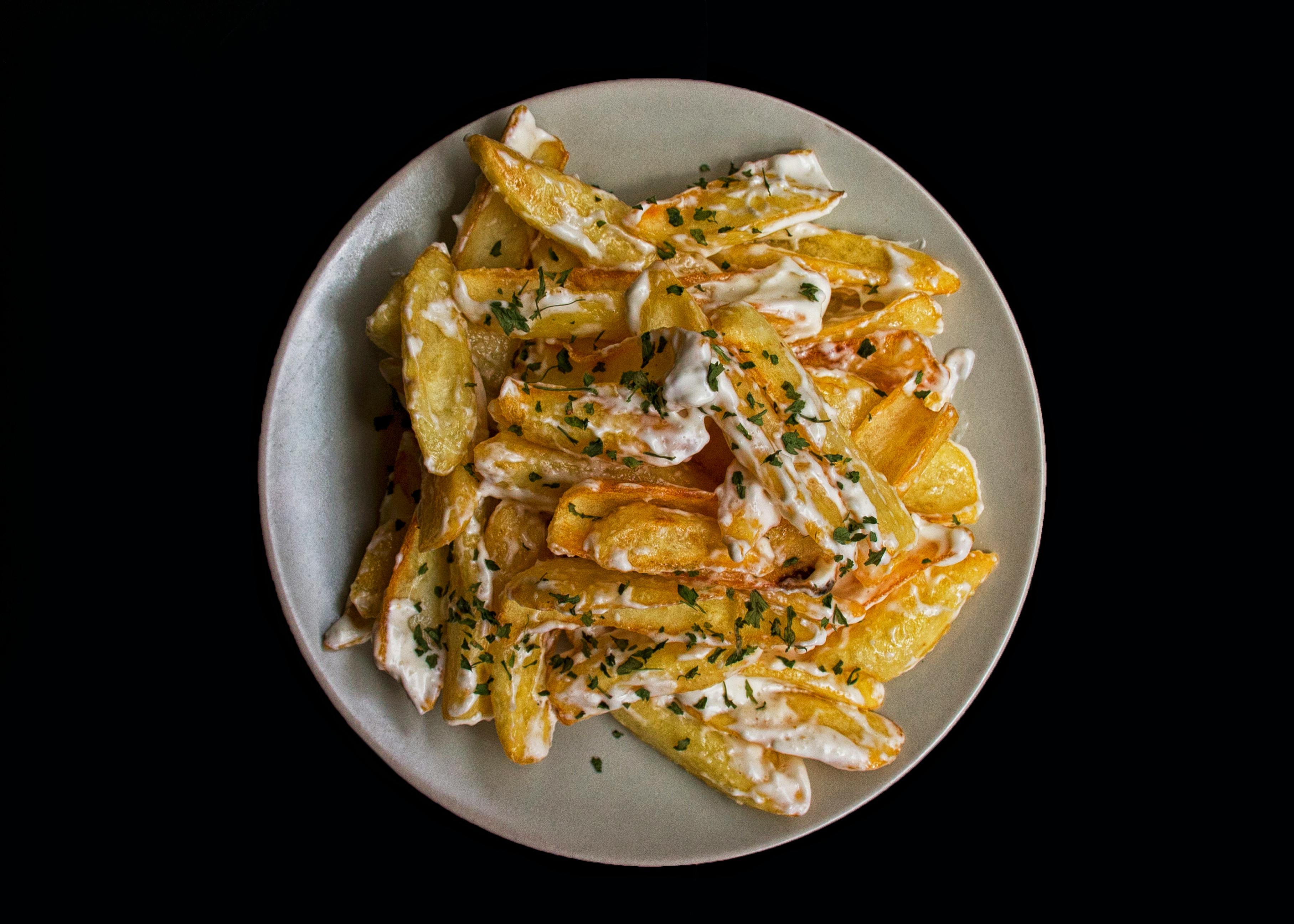 Cooked Potato Wedges With Mayonnaise and Green Herbs · Free Stock Photo