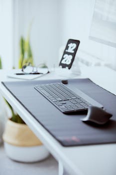 Sleek office desk setup featuring a wireless keyboard and mouse, perfect for productivity.