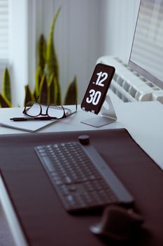 A stylish workspace featuring a computer keyboard and smartphone in a well-lit environment.