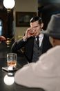 Photo of Man in Black Suit Holding Clear Drinking Glass