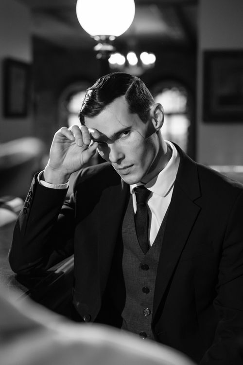 Free Moody black and white portrait of a man in vintage attire, evoking film noir. Stock Photo