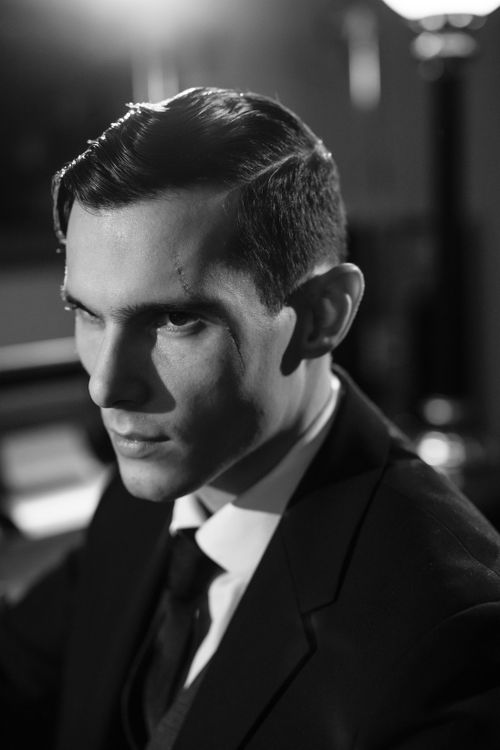 Free A cinematic black and white portrait of a serious-looking man indoors, giving a noir vibe. Stock Photo