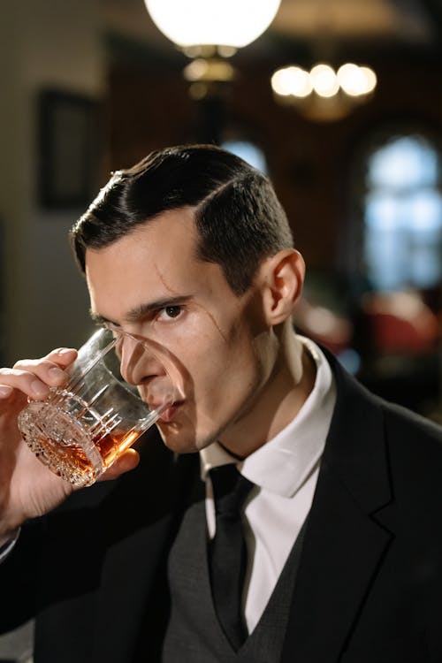 Photo of Man Drinking from Glass of Whiskey