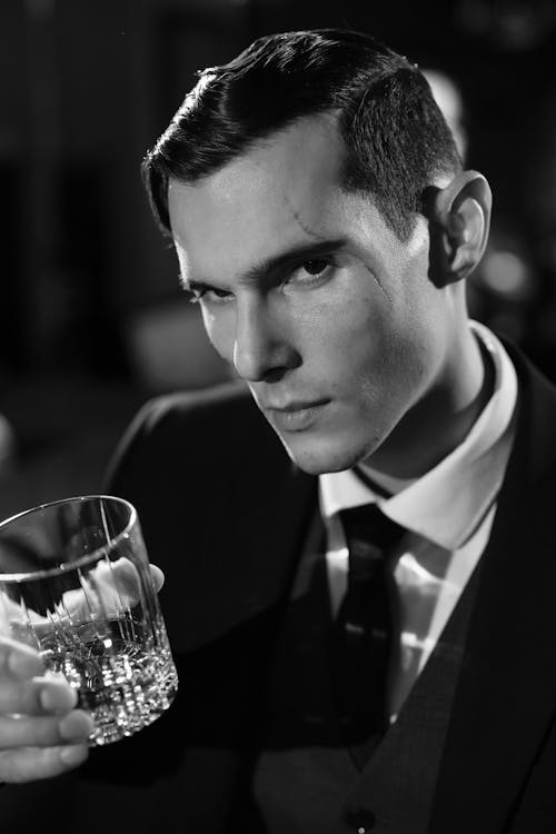 Close-Up Photo of Man Holding Clear Drinking Glass