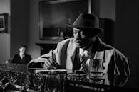 Monochrome Photo of Man Taking Notes