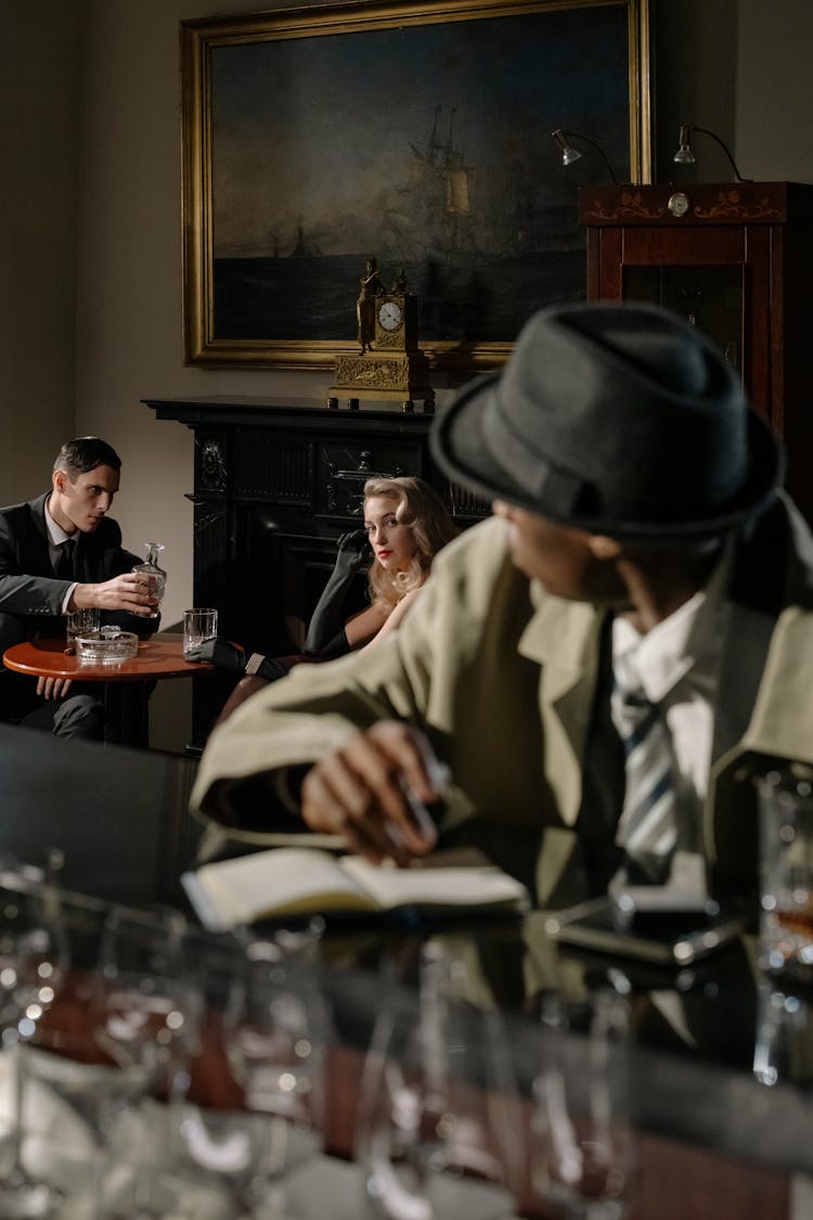 Photo Of Person Sitting In Front Of Bar Counter