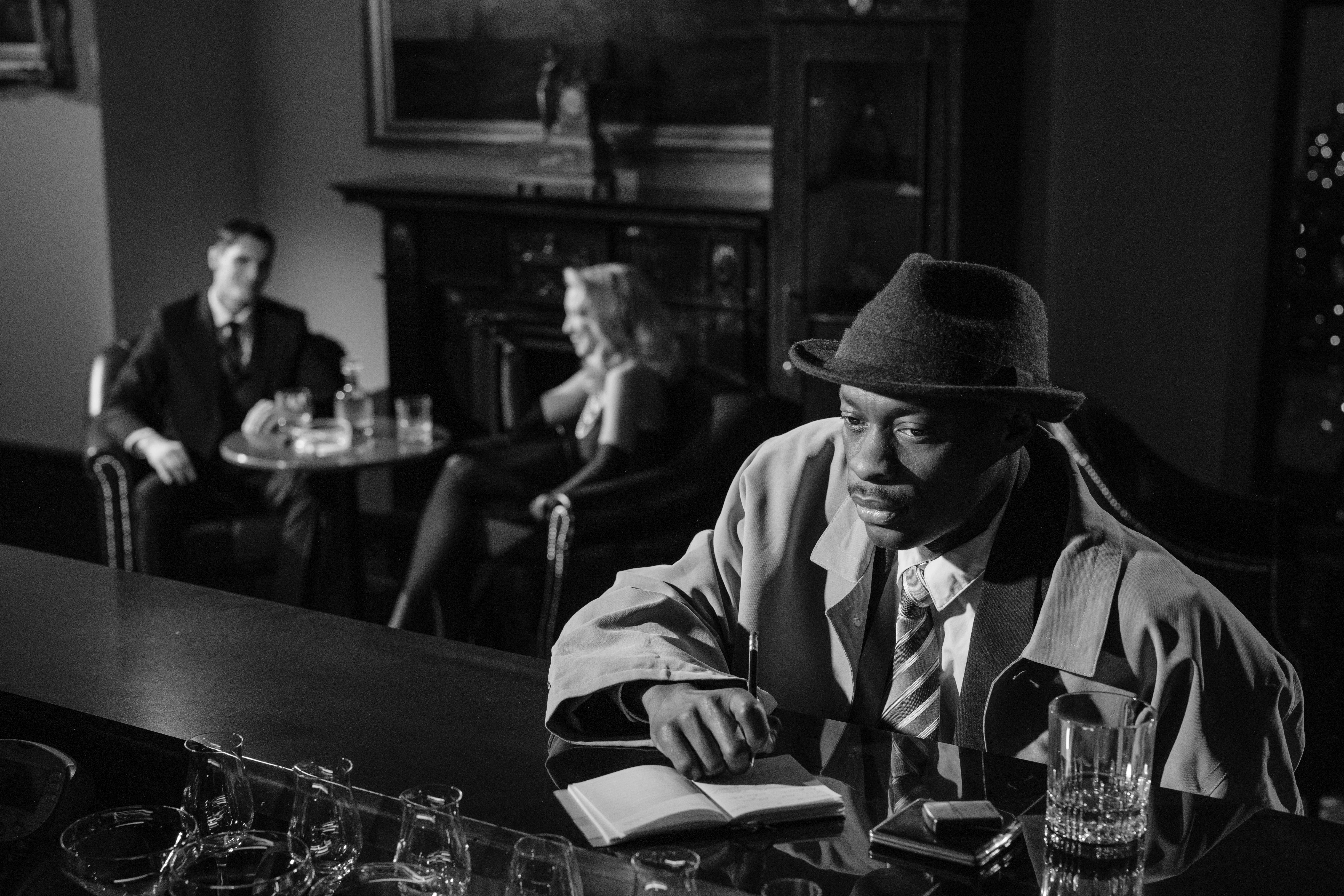 photo of man sitting in front of bar counter