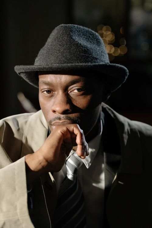 Free Portrait of a moody detective in a fedora hat exuding mystery. Stock Photo