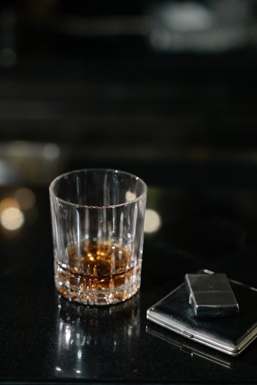 Photo of Clear Glass with Whiskey on Counter Top