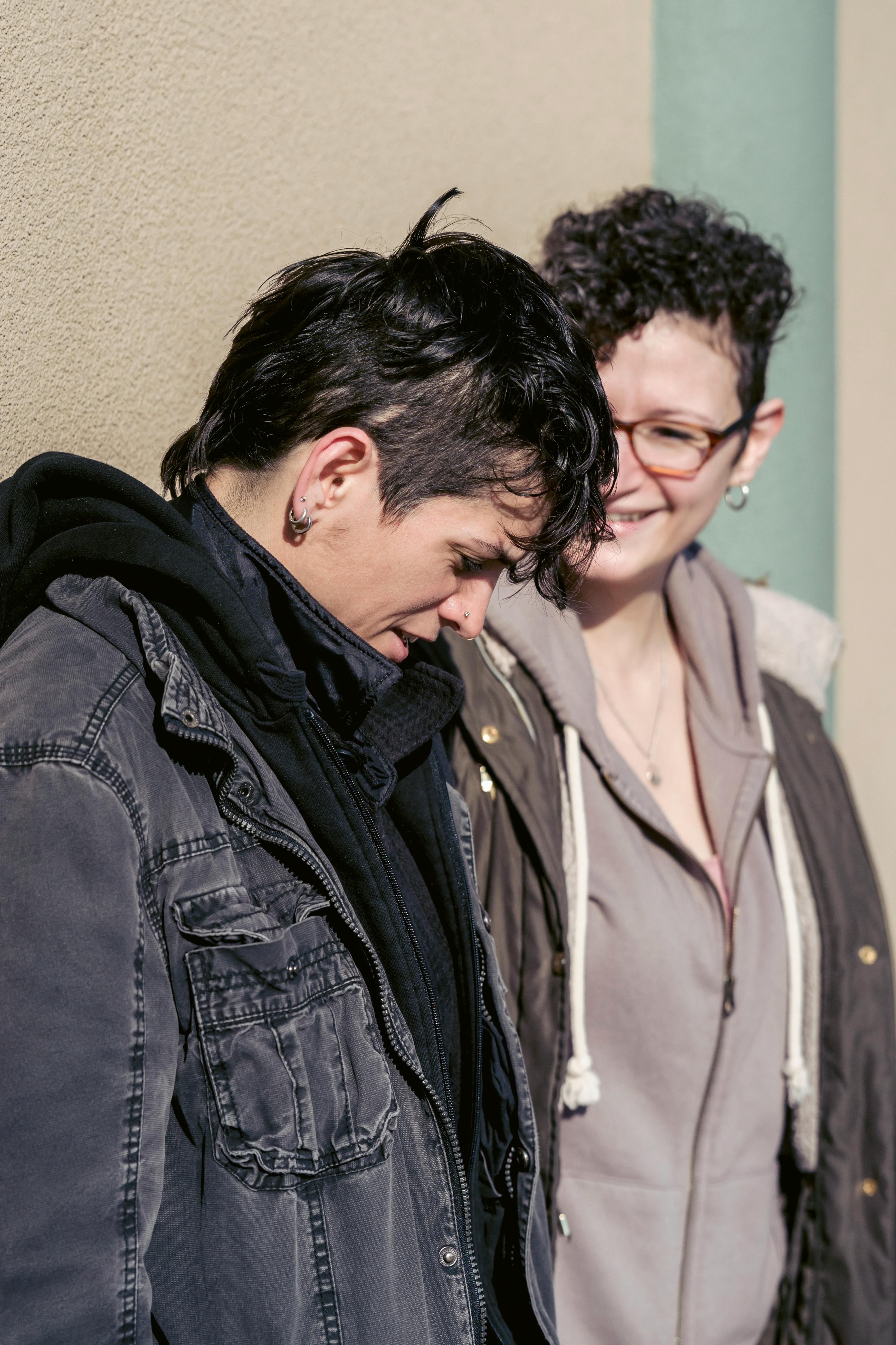 positive lesbian couple walking on sunny street