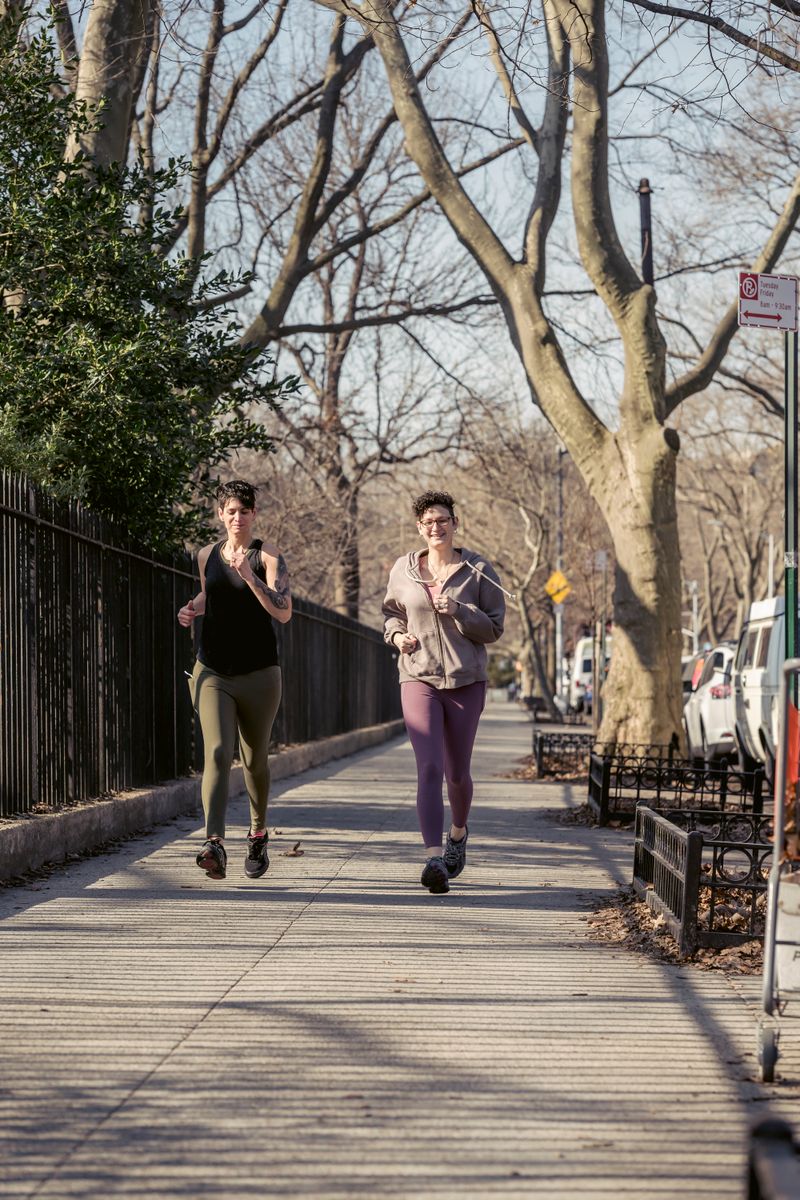 Two runners on a tree-lined street, photo by Sarah Chai on Pexels