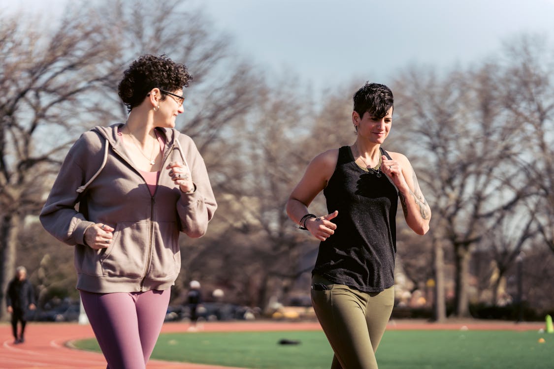 Free Young girlfriends running at stadium Stock Photo