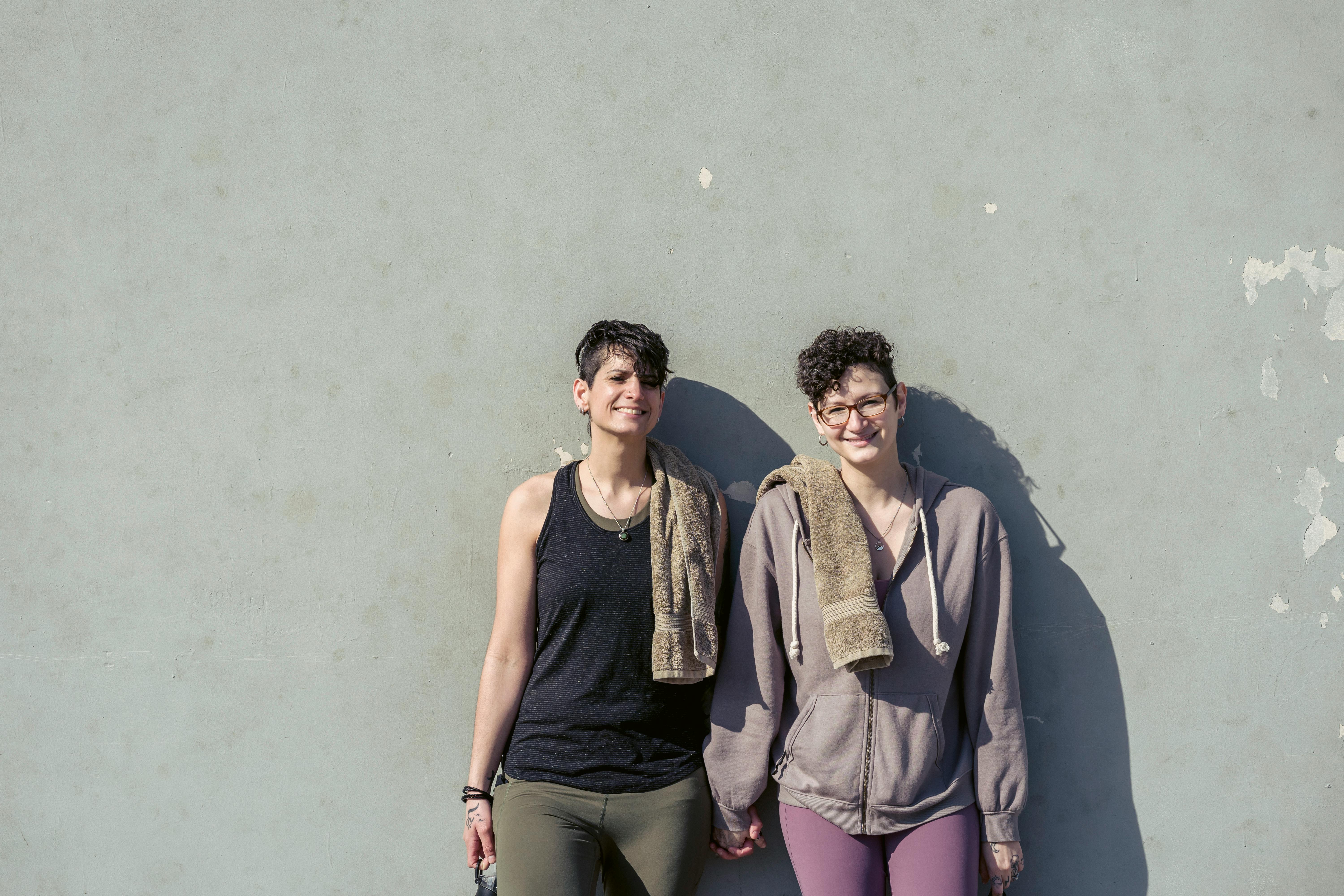 happy lesbian sportswomen holding hands