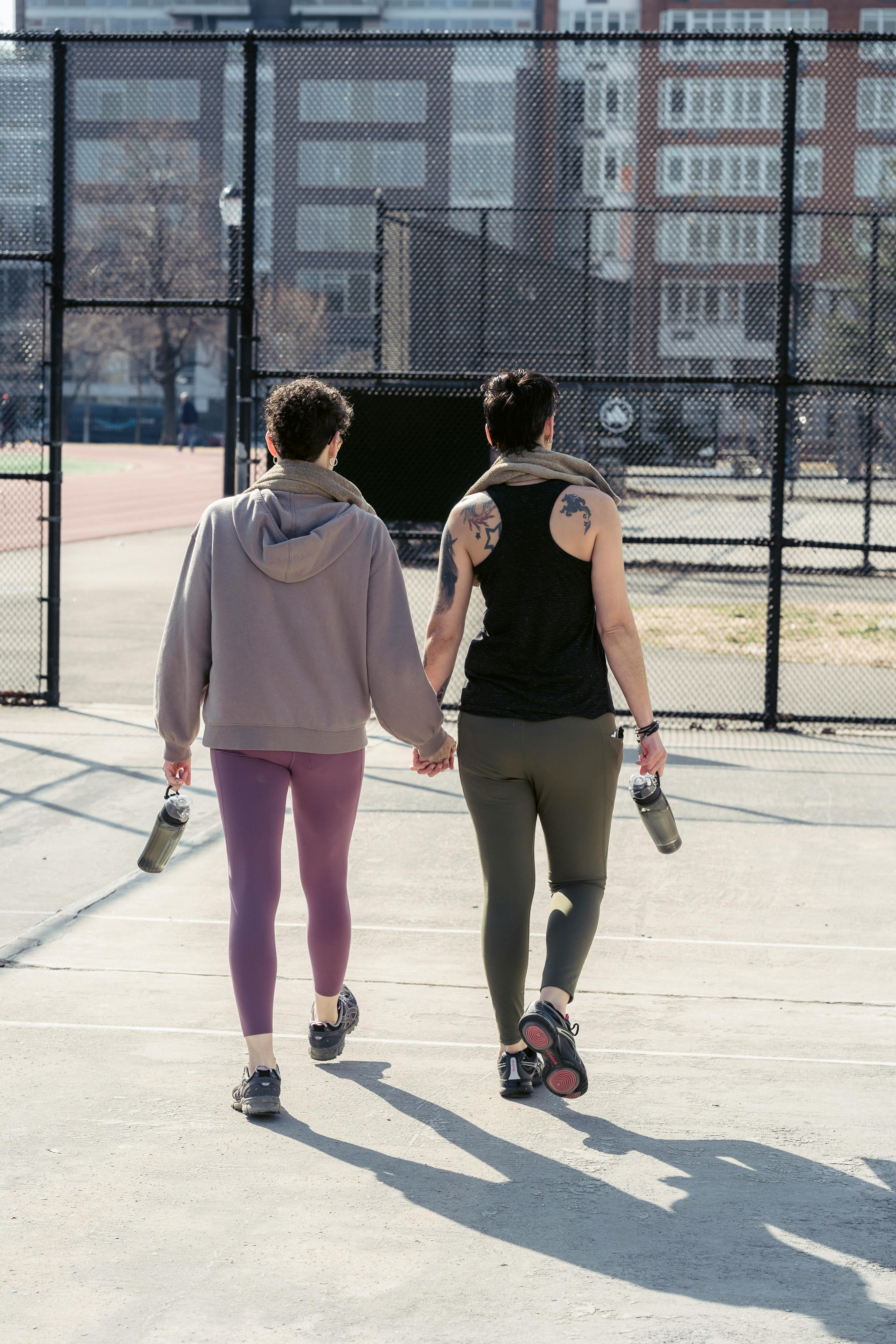 girlfriends walking to sports ground together