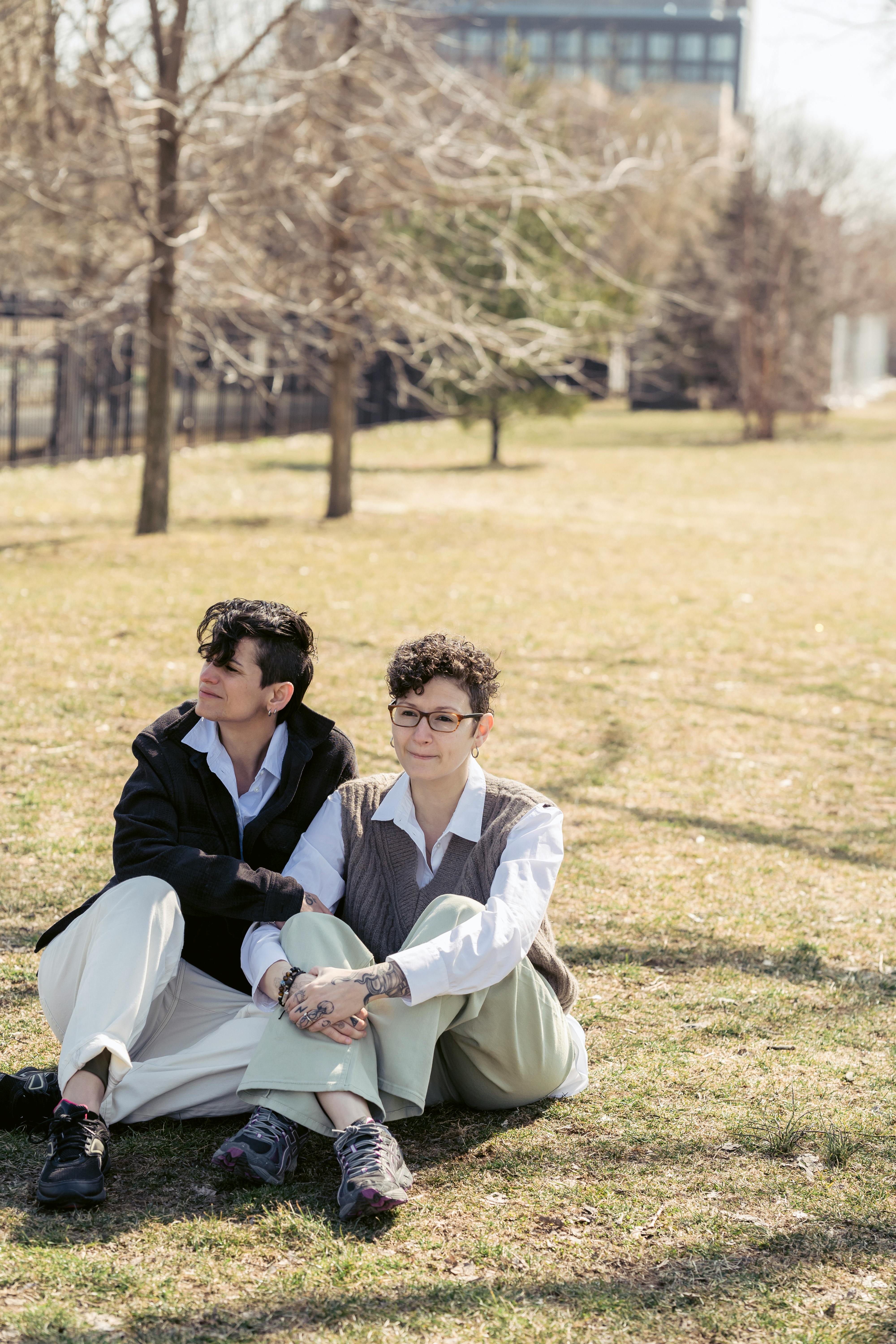 young stylish women resting on lawn in city park