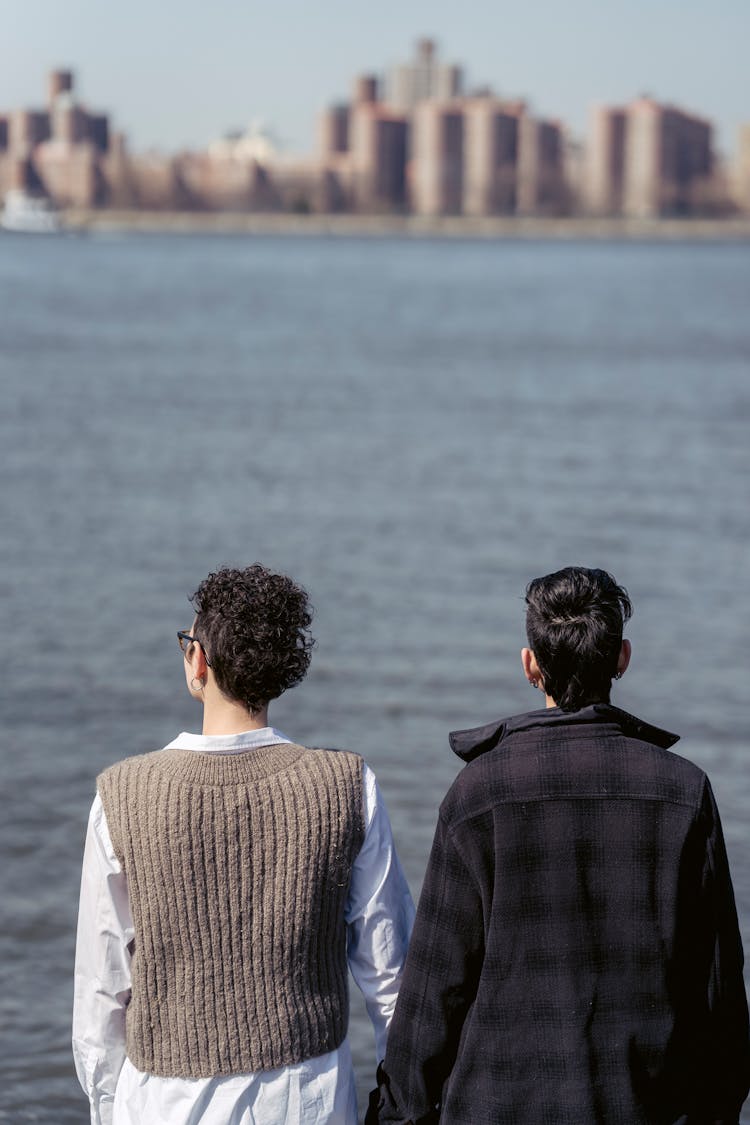 Best Friends Admiring River And Skyscrapers Of City