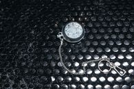 Silver Round Pendant on Black Background