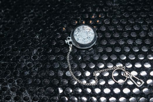 Silver Round Pendant on Black Background