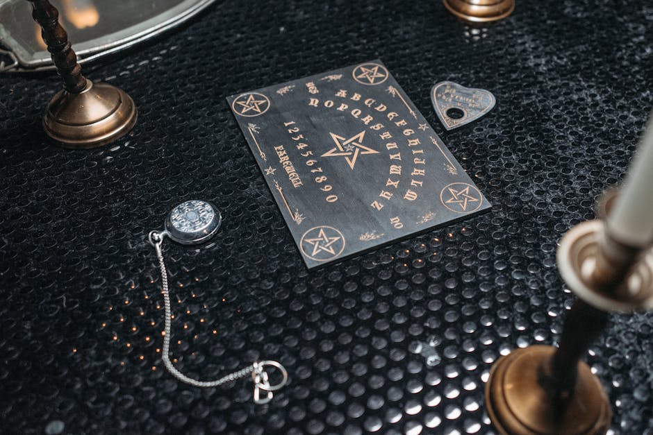 A mystical Ouija board setup on a textured black table, surrounded by candles and spiritual items.