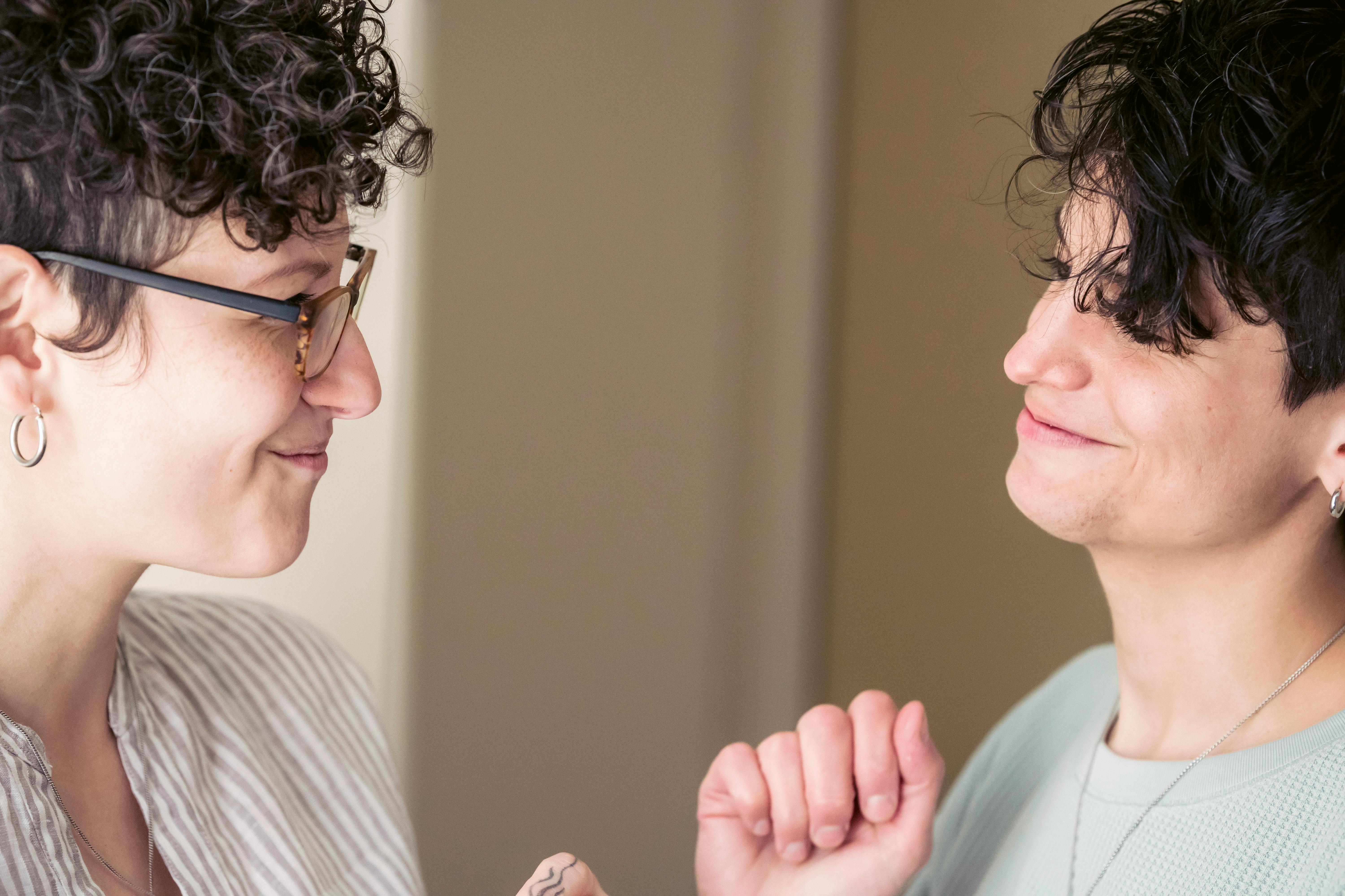 happy female friends chatting and smiling at home