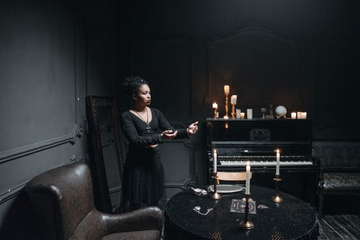 Woman Standing in Black Room Illuminated by Cand