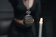 Close Up Shot of a Silver Round Pendant