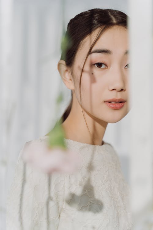 A Woman in White Floral Lace Shirt