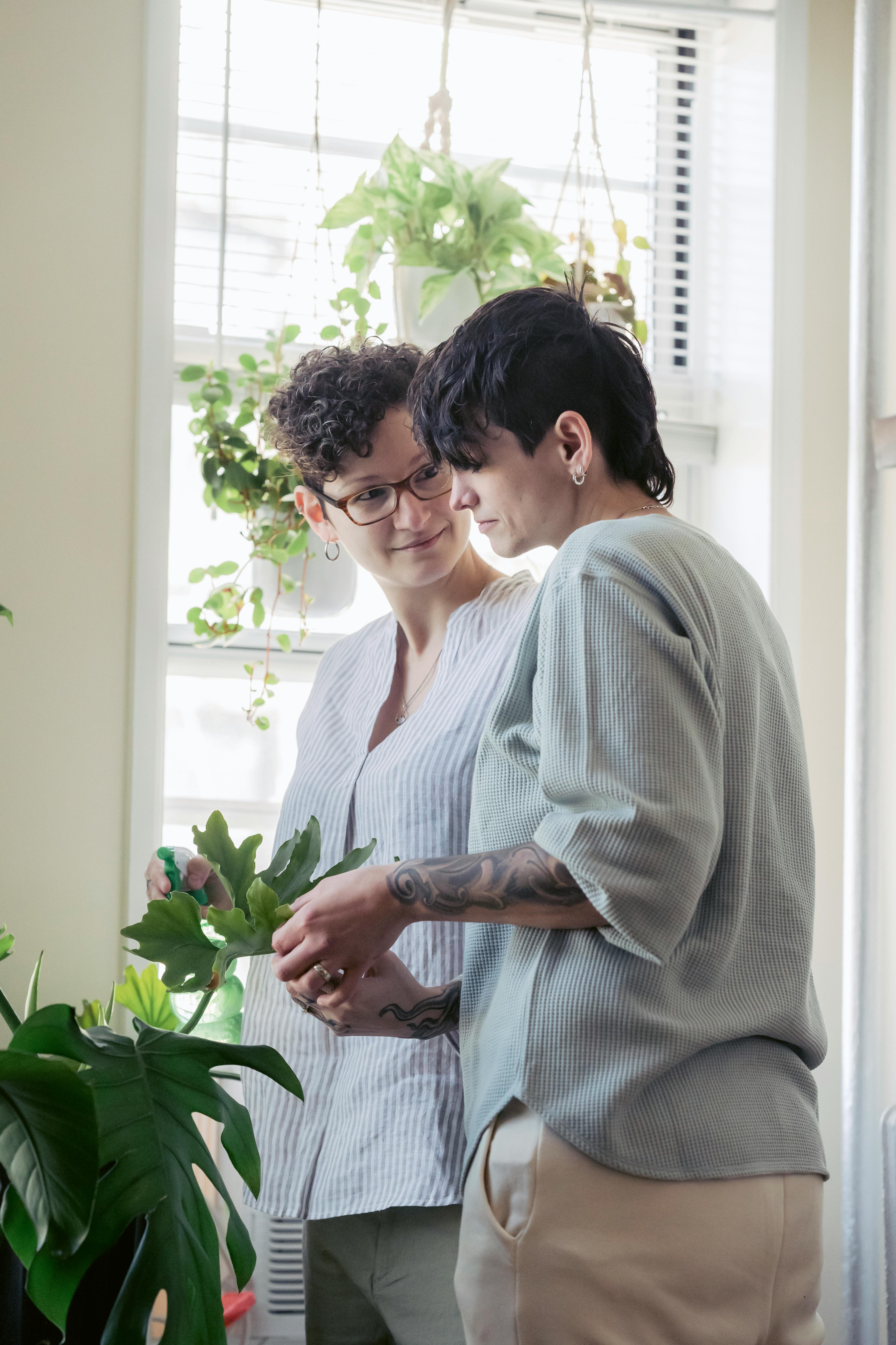 homosexual women talking among plants at home