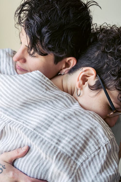 Free Man in White and Gray Plaid Shirt Hugging Woman Stock Photo