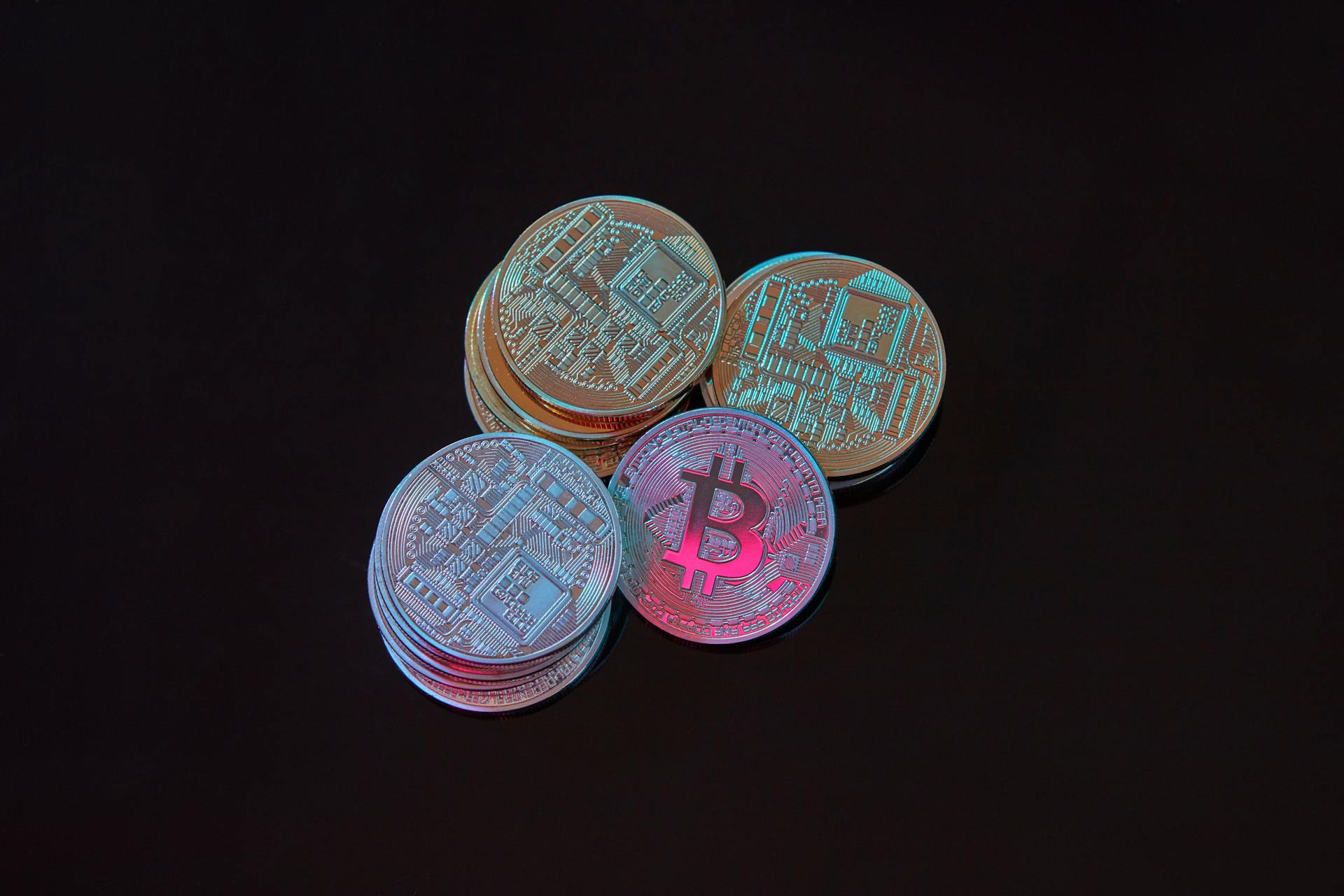 A detailed image showcasing a stack of Bitcoin cryptocurrency coins on a black background.