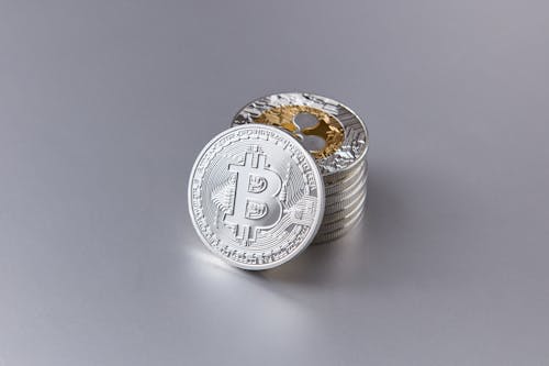 Stack of Shiny Coins with Cryptocurrency Logo