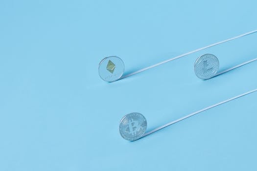 Minimalist image of Bitcoin, Ethereum, and Litecoin coins on a baby blue background.