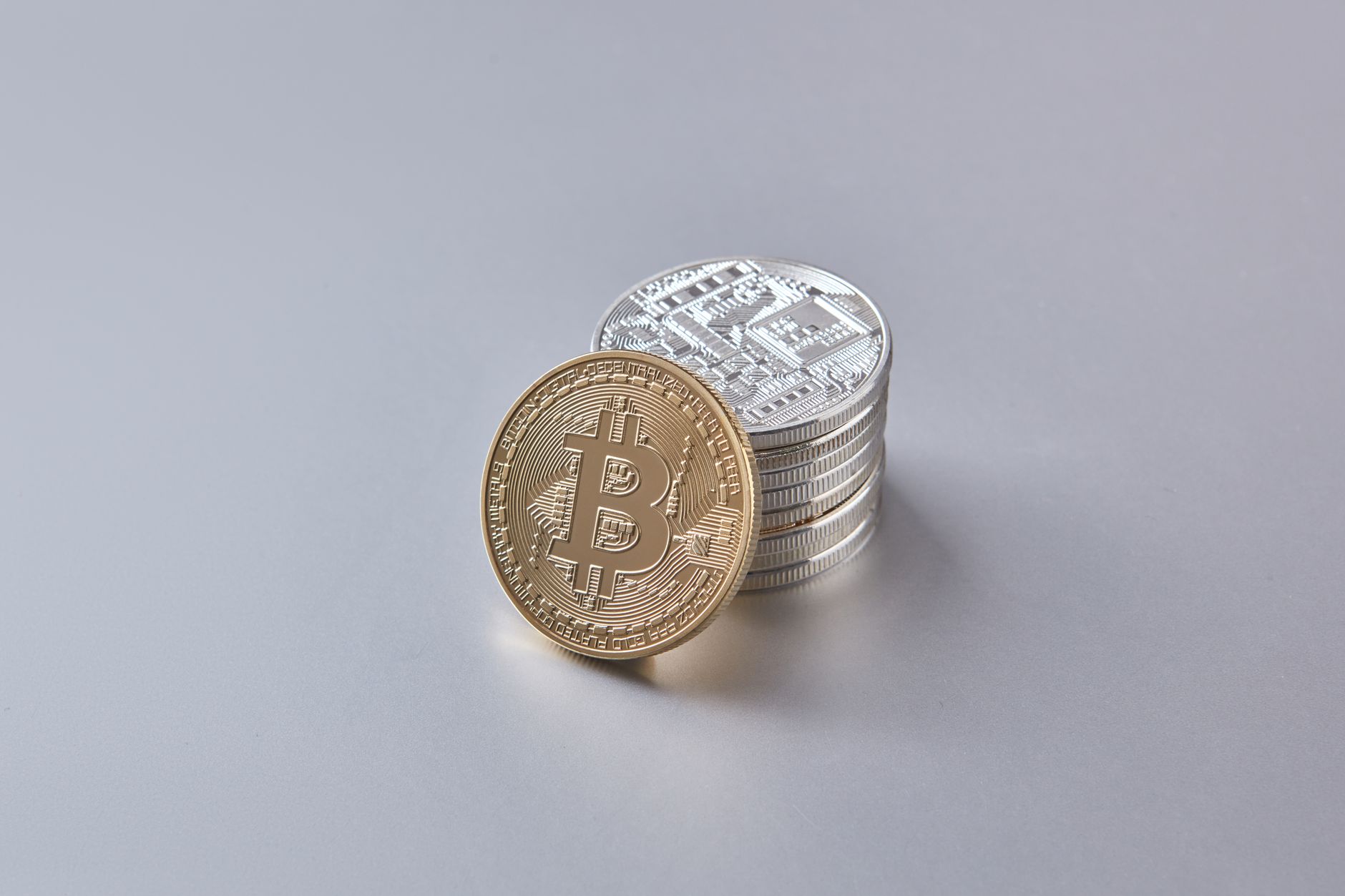 Stack of Bitcoin and cryptocurrency coins representing digital currency and financial wealth.