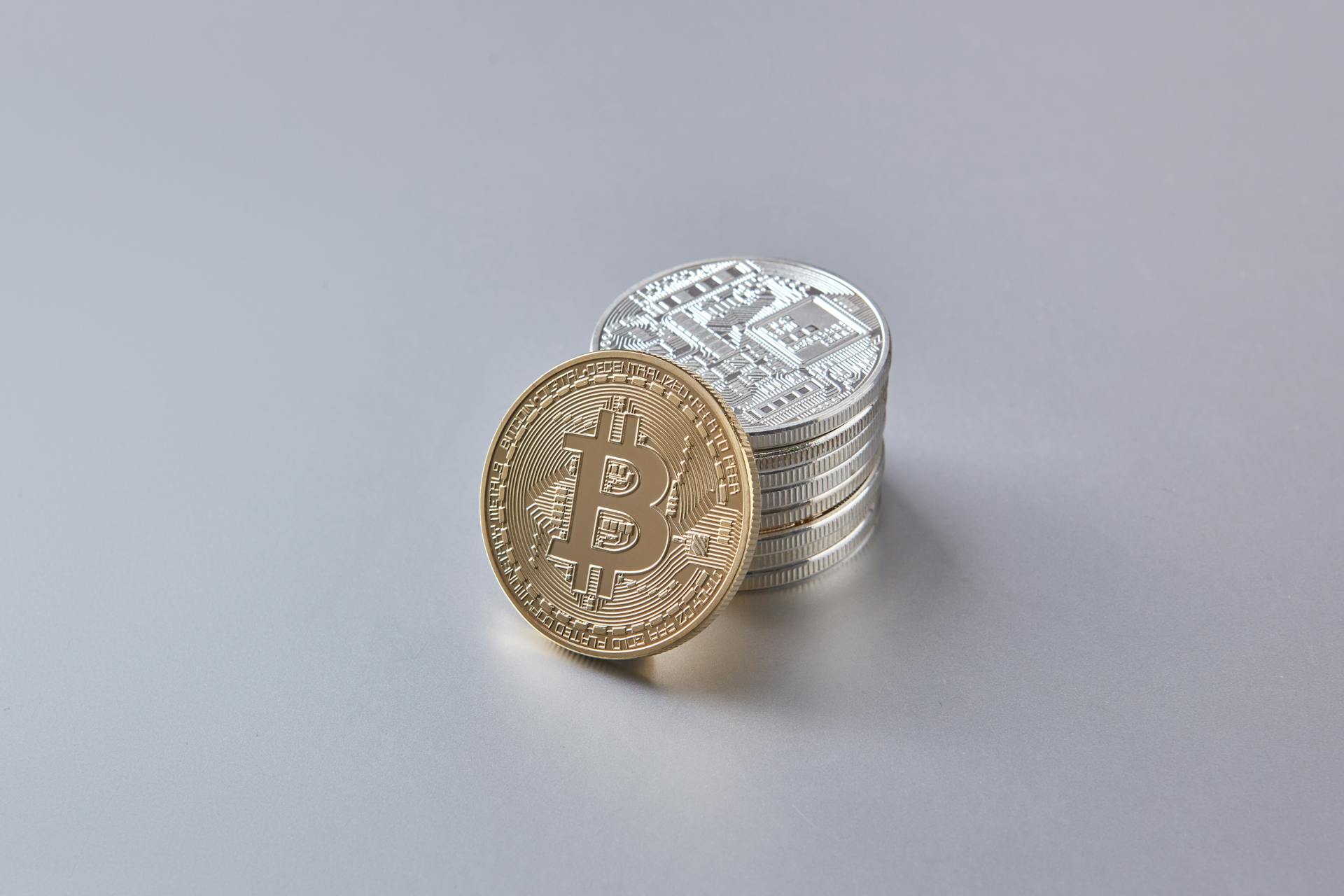 Stack of Bitcoin and cryptocurrency coins representing digital currency and financial wealth.