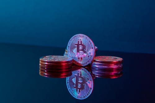 Free Photo of Bitcoins Illuminated by a Purple Light Stock Photo