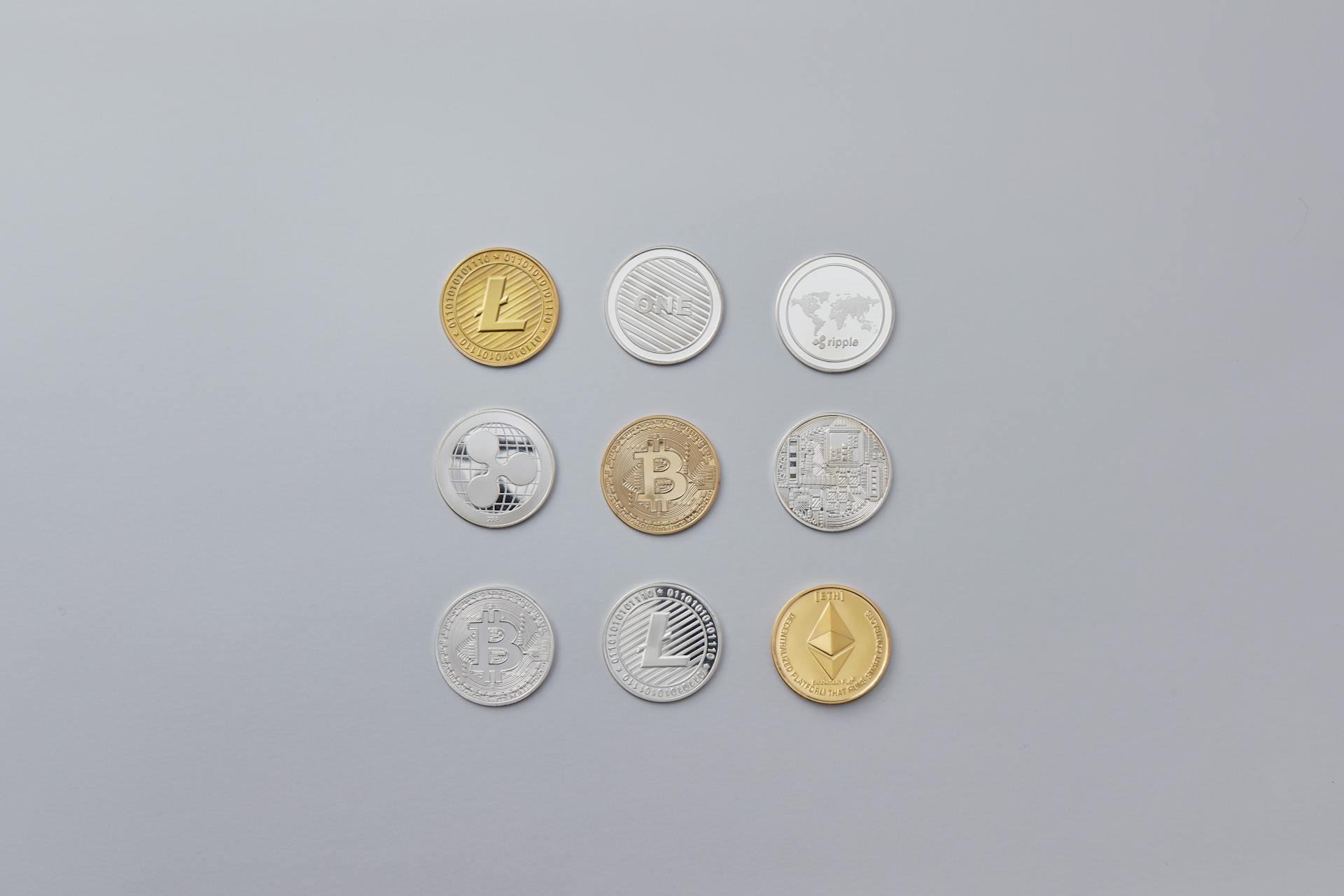 Silver and Gold Round Coins on Grey Background