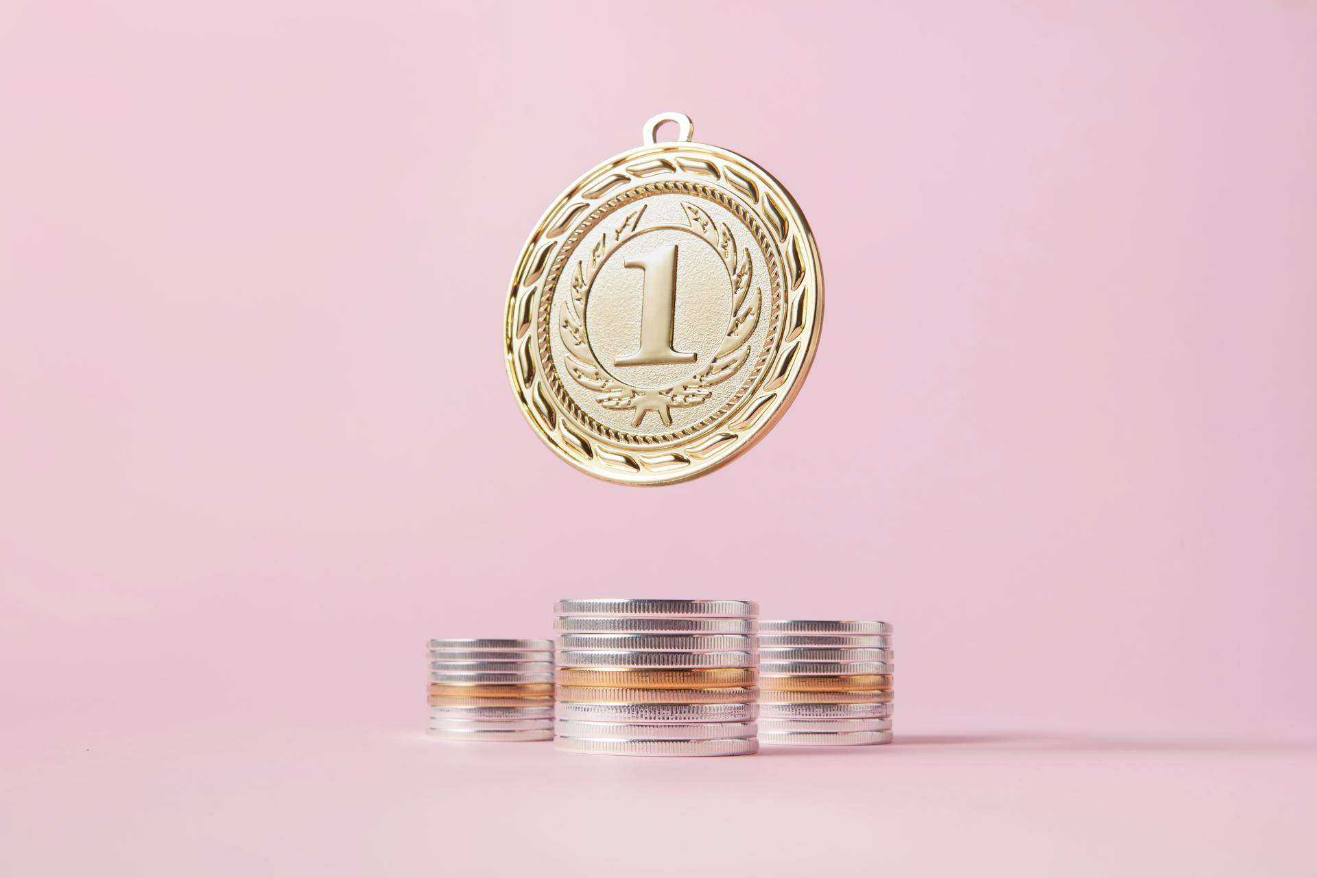 Gold Medal on Top of Coins