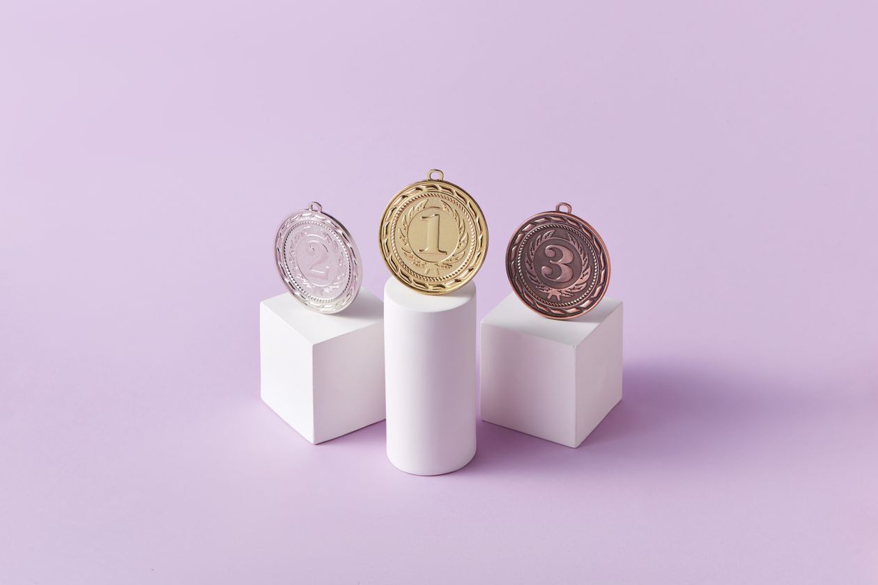 Gold silver and bronze medals on podiums ranking the best referral marketing software