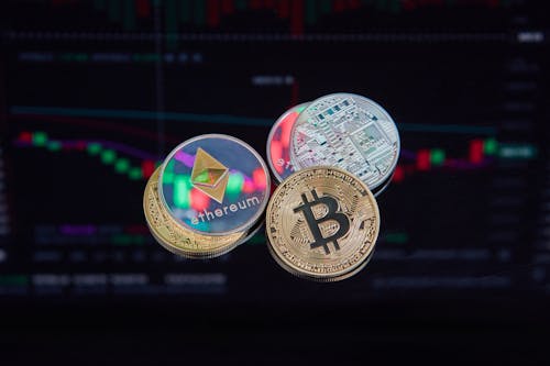 Coins with Cryptocurrencies Symbols on the Background of Graphs 