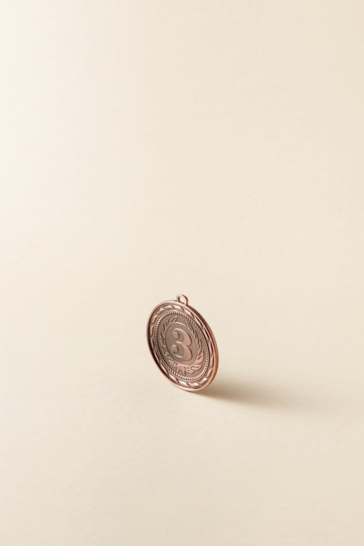 Bronze Round Coin On Beige Surface