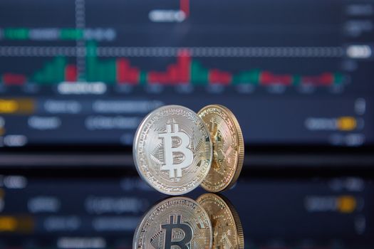 Bitcoin coins with a stock market background representing cryptocurrency and trading.