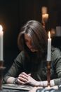 Woman in Praying Near a Burning Candle