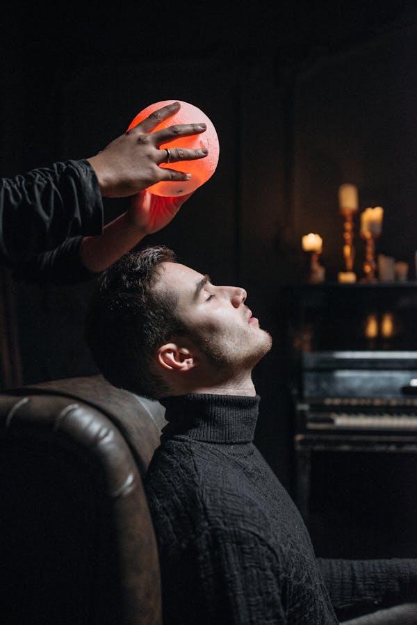 Man in Black Suit Jacket Holding Orange Ball