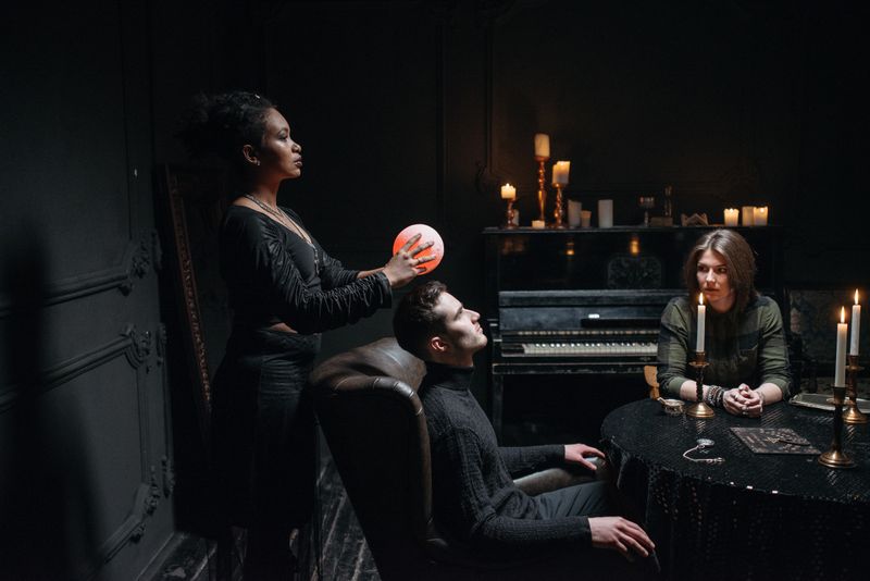 A mystical scene with a crystal ball and candles creating a spiritual atmosphere