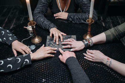 Hands on a Ouija Board