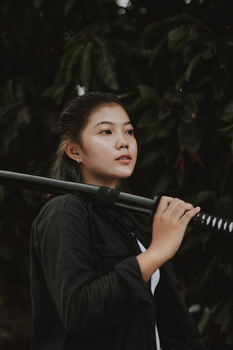 A Woman Holding A Katana