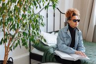 Person Sitting on Bed While Using a Braille